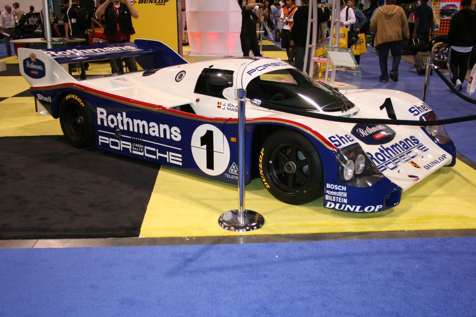 Rothmans Porsche 962 Le Mans race car side view at an auto show