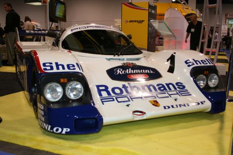 Rothmans Porsche 956 race car front three-quarter view at an auto show