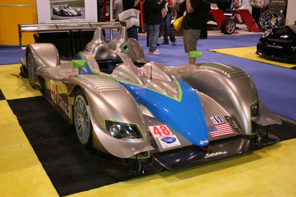 Silver and blue Le Mans prototype race car front three-quarter view