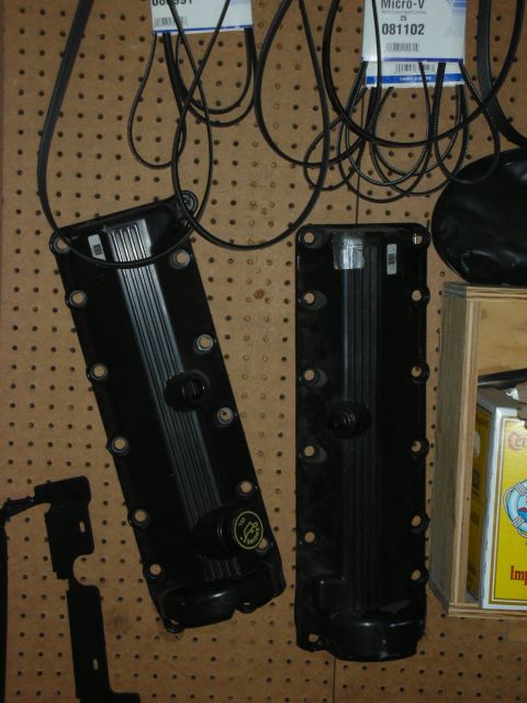 1998 Ford Crown Victoria - Photograph of valve covers hung on a pegboard, not a technical document.