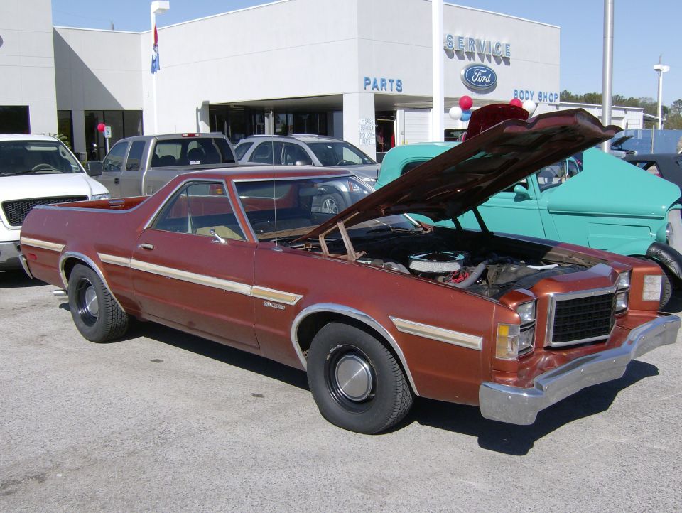 1979 Ford Ranchero coupe utility with hood open in front of a Ford dealership.