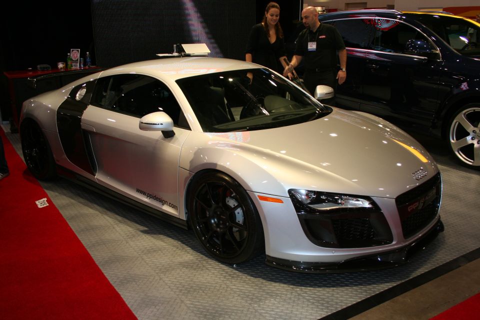 Silver Audi R8 coupe on display at an indoor car show