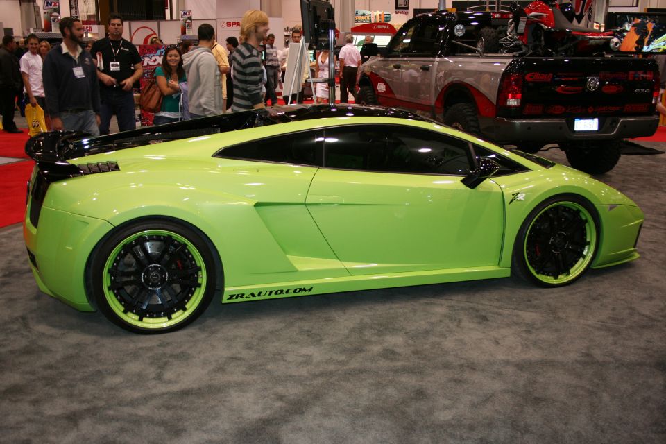 Green Lamborghini Gallardo side profile at a trade show