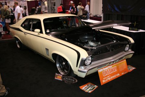 Cream and black custom Chevy Nova on a giveaway show stand