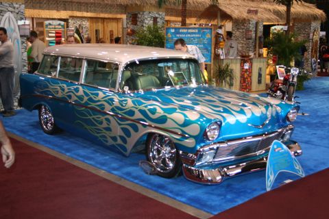 Blue and silver customized station wagon with flame graphics, chrome wheels, and a two-tone roof