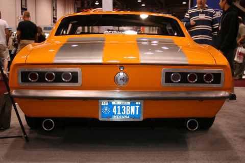 Orange muscle car rear with silver stripes and custom taillights