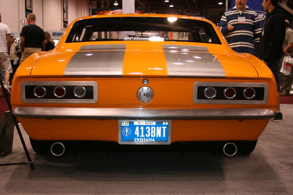 Orange muscle car rear with silver stripes and custom taillights