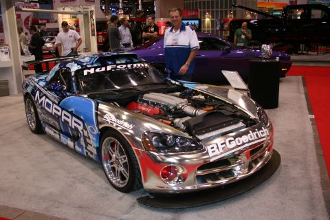 Chrome Mopar Dodge Viper race car with open hood at show
