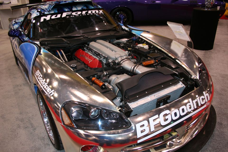 Chrome Mopar Dodge Viper engine bay open hood at trade show
