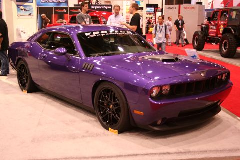 Purple Dodge Challenger custom car at a trade show booth