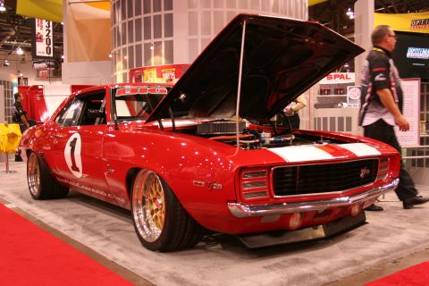 Red number 1 race-livery Camaro with open hood at trade show