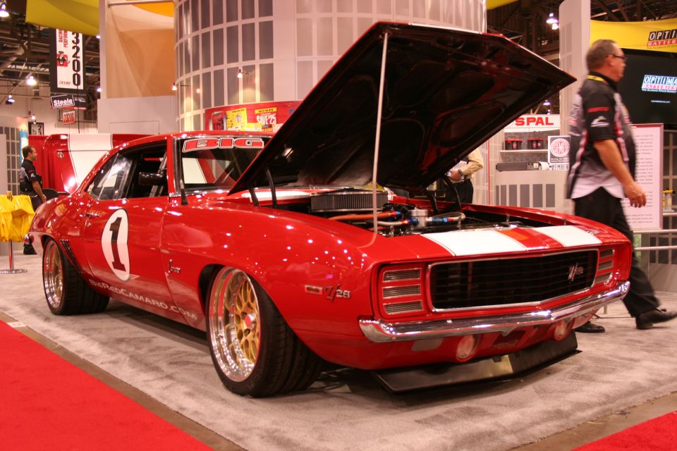 Red number 1 race-livery Camaro with open hood at trade show