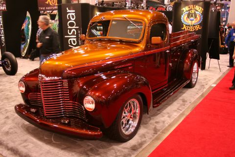 Custom candy-orange International pickup truck on a show floor