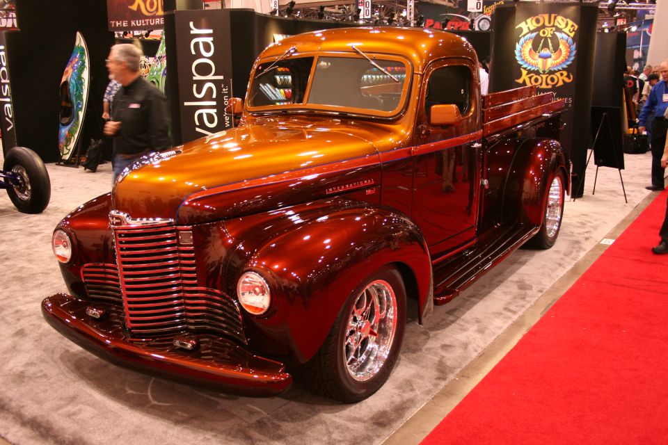 Custom candy-orange International pickup truck on a show floor