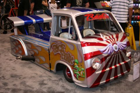 Custom lowered van with rising-sun and flame paintwork at a show
