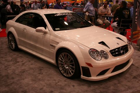 White Mercedes-Benz CLK coupe with body kit on a show floor