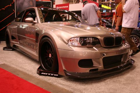 Silver widebody BMW E46 M3 with front splitter at a show