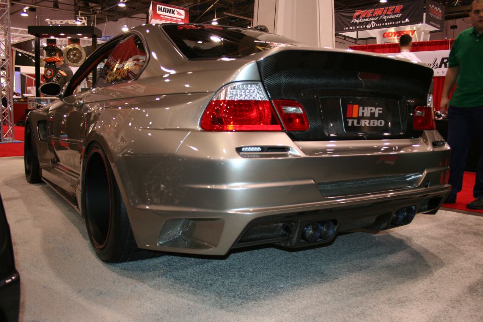 Silver widebody BMW E46 M3, rear three-quarter view at a show