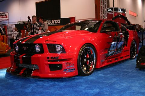 Red and black widebody Ford Mustang show car, front three-quarter