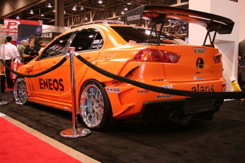 Orange Mitsubishi Lancer Evo with ENEOS livery and big wing