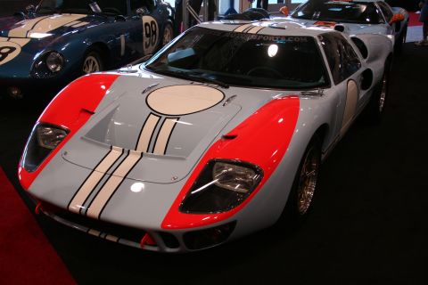 White and red Ford GT40 replica with circular roof scoop, front view
