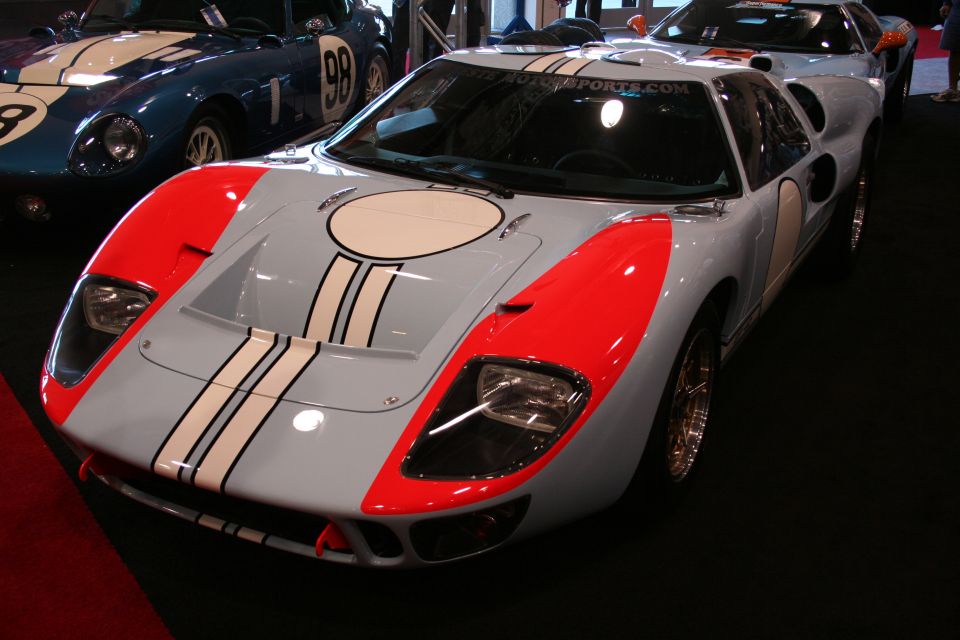 White and red Ford GT40 replica with circular roof scoop, front view
