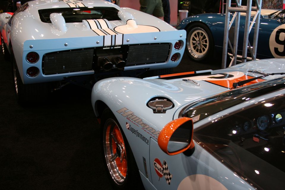 Gulf-livery Ford GT40 replicas displayed at an auto show