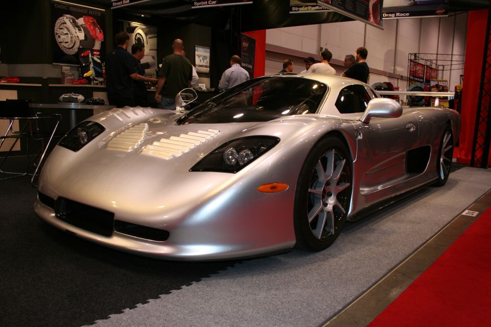 Silver sports car with aggressive front end and large wheels on display