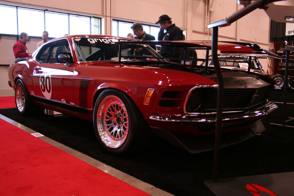 Red 1970s muscle car with racing stripes and number 30 on the door