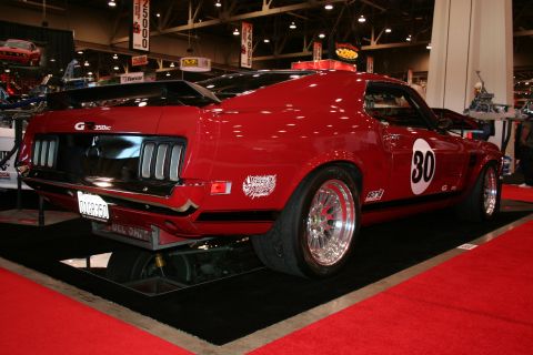 Red 1969 Ford Mustang Boss 302 with racing stripes and number 30 on the door