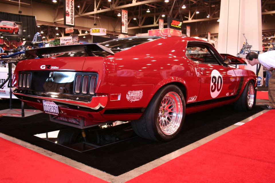 Red 1969 Ford Mustang Boss 302 with racing stripes and number 30 on door