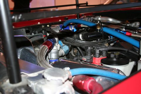 Engine bay with braided lines and blue and red hoses