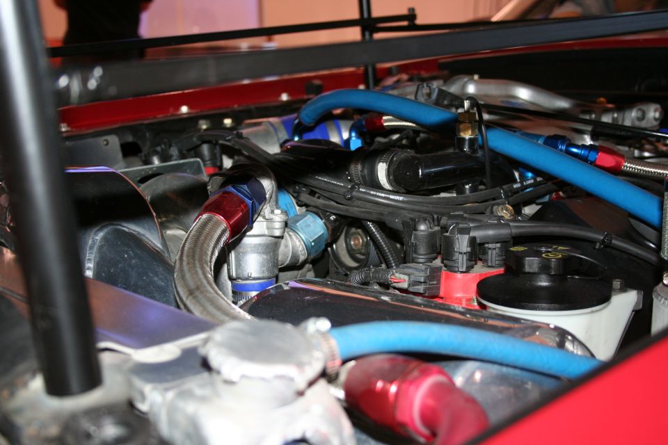 Engine bay with braided lines and blue and red hoses