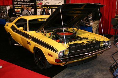 Yellow 1970 Dodge Challenger T/A with black stripes, hood open, showing engine