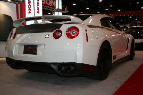 White Nissan GT-R with spoiler and quad exhaust pipes. Sebon license plate frame visible