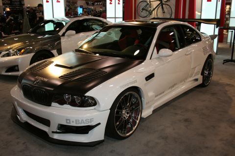 White BMW M3 with black hood, large spoiler, and racing decals