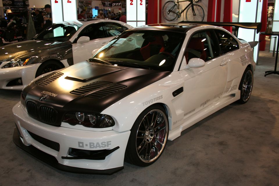 White BMW M3 with black hood, large spoiler, and racing decals