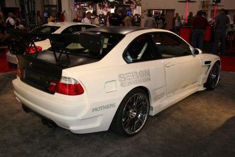 White coupe with a large rear spoiler and custom body kit. 'SEBON CARBON' is visible on the side