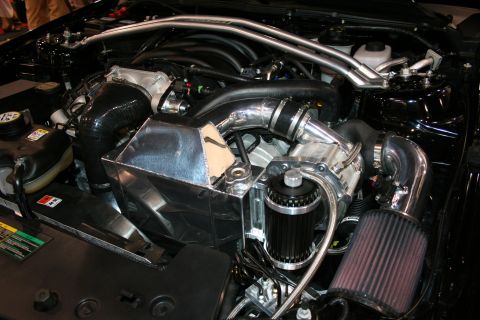 Engine bay showing a turbocharger, intercooler piping, and air filter