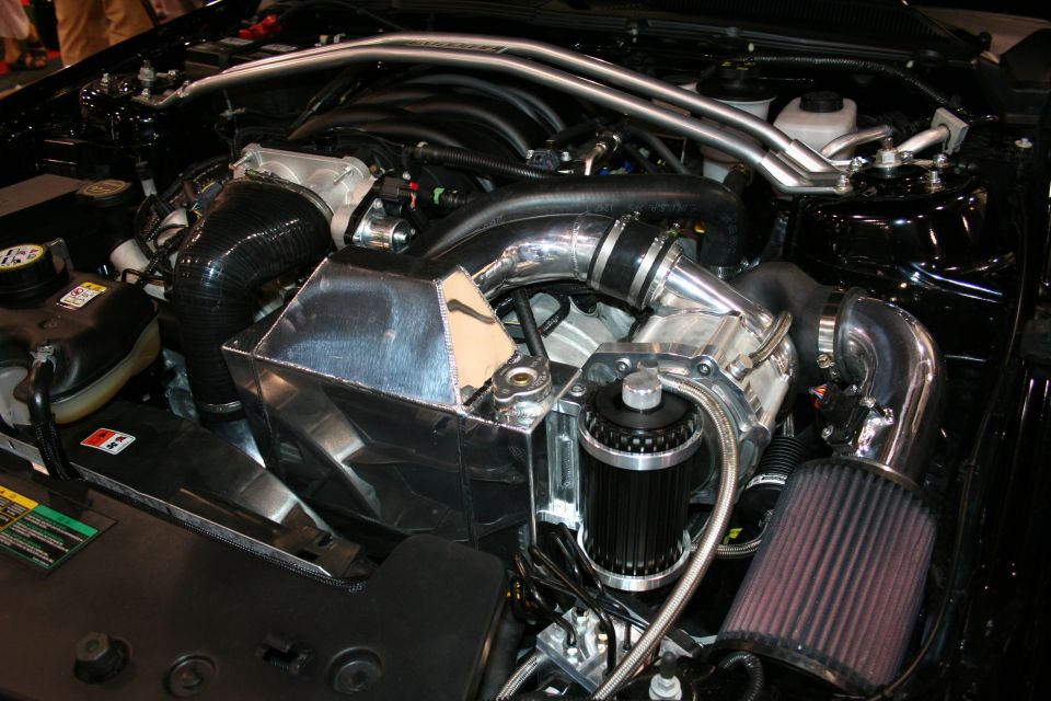 Engine bay showing a turbocharger, intercooler piping, and air filter