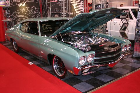 Light blue 1970 Chevrolet Chevelle SS with hood open, showing a polished engine and custom wheels