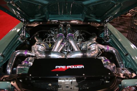 Engine bay with twin turbochargers and chrome piping. Black cover reads 'PPE POWER'