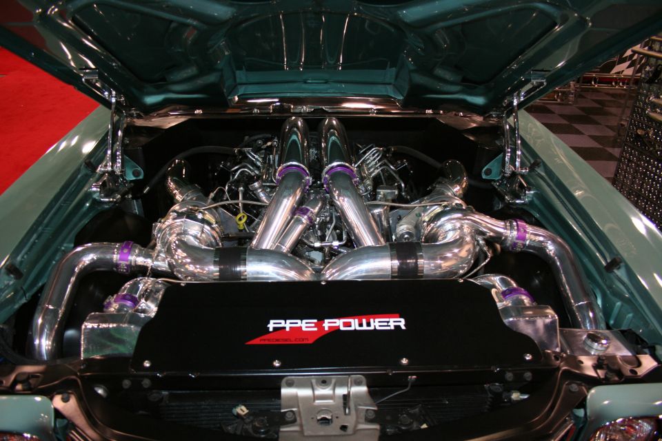 Engine bay with twin turbochargers and chrome piping. Black cover reads 'PPE POWER'