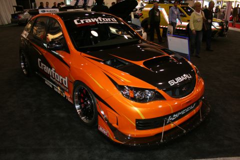Orange and black Subaru Impreza WRX STI race car with Crawford Performance livery, front view