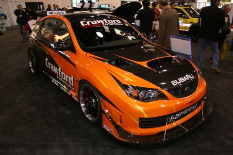 Orange and black Subaru Impreza WRX STI hatchback with racing decals