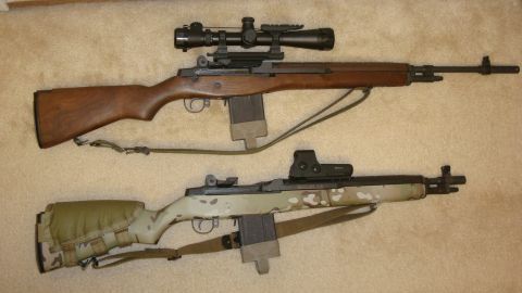 1990 Ford Bronco - Two rifles are displayed, one with a wooden stock and scope, the other with a camouflage finish and red dot sight.
