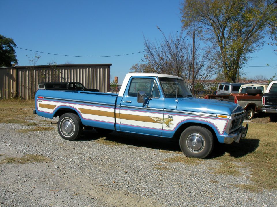 1976 Ford F-150 pickup truck, blue with white roof and gold/pink side stripes