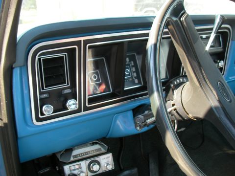 1976 Ford F-150 - Interior view of a 1976 Ford F-150, a blue dashboard and steering wheel.