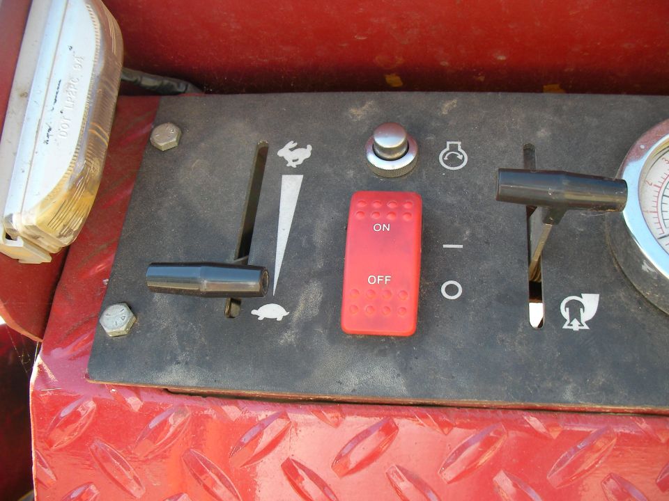 Red control panel with black levers, a red ON/OFF switch, and a gauge