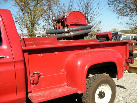 1979 Ford F-350 - A red 1979 Ford F-350 fire truck is parked outdoors with a hose reel visible in the bed.